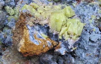 Nodule of Oregon blue clay, coated with red clay and sulfur crystals encased in white clay.